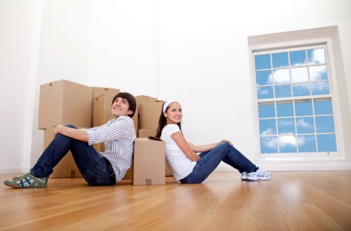 Professional movers carrying furniture during a Whitton house move