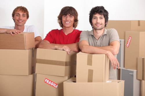 Moving team unloading boxes at a new Whitton home